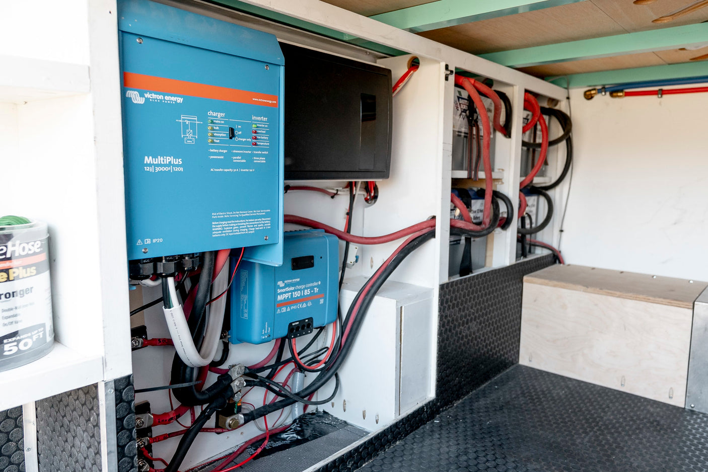 Inside an RV rental: Victron MultiPlus inverter, SmartSolar MPPT, and battery bank for off-grid power.