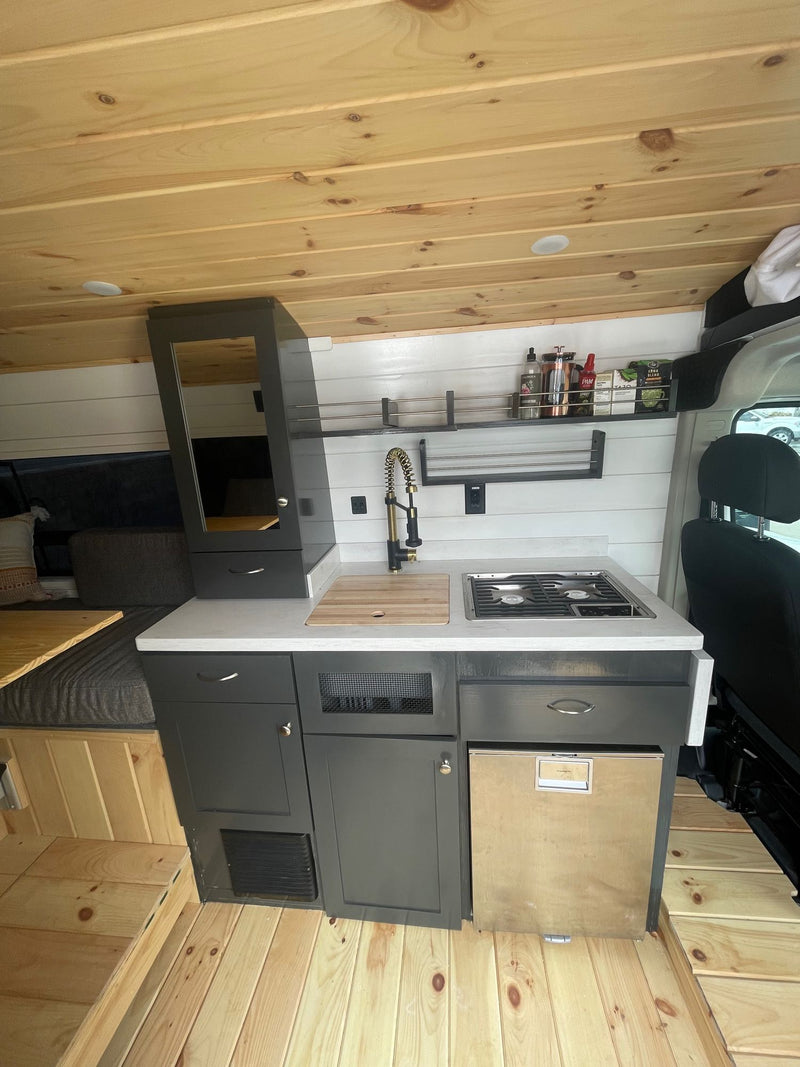  and built-in kitchen area.|Spacious RV rental interior: light wood ceiling/floor — photo 5