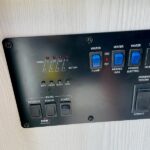 RV rental control panel: view switches, digital display, & indicators for water pump, heater, and tank levels. — photo 11