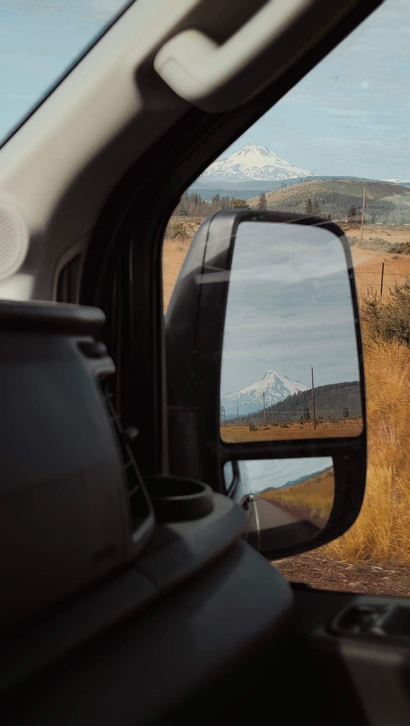  perfect for off-grid travel.|Woman reading in a converted van's cozy interior — photo 11