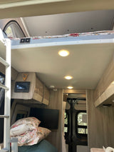 RV rental interior: features a cozy bunk bed with USB ports, control panel, and a TV in the main living area.