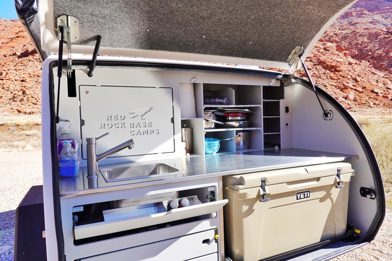 This RV rental's rear galley offers a fully equipped outdoor kitchen with sink, storage, and Yeti cooler for your camping trips. — photo 11