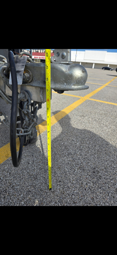 This RV rental trailer hitch is measured at approximately 17.5 inches from the ground for proper towing setup.