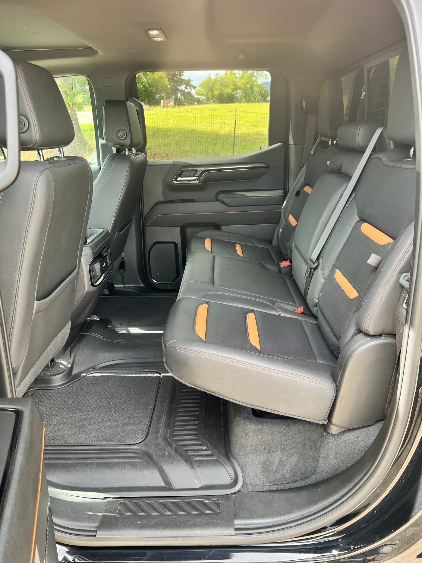 Roomy rear cabin of a modern truck, perfect for an RV rental adventure. One rear seat folds up for expanded cargo area. — photo 8