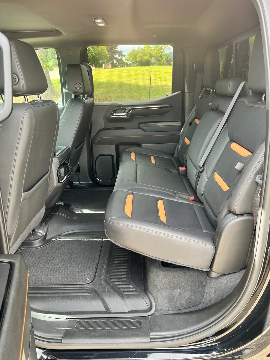 Roomy rear cabin of a modern truck, perfect for an RV rental adventure. One rear seat folds up for expanded cargo area.