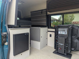 Explore this rv rental camper van interior: compact kitchenette with fridge, clever storage, and adaptable EZ Mount seating system.