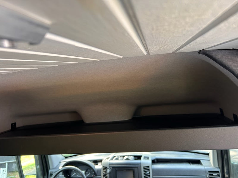  and a comfy bed area visible.|RV rental interior: view of the front cab — photo 8