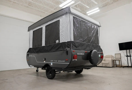 This gray Rockwood OTG pop-up camper rv rental is ready for adventure. Features canvas sides, clear windows, and a rear spare tire.
