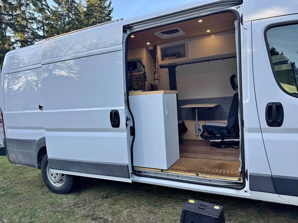 Inside an RV rental camper van: custom-built interior with kitchen