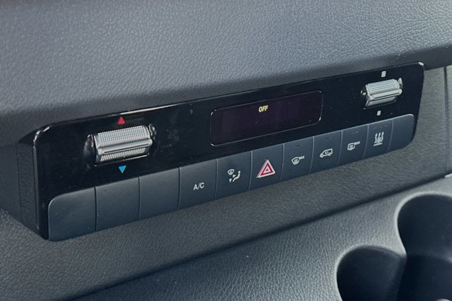 RV rental interior: Climate control unit with temperature/fan knobs, digital 'OFF' display, and buttons for A/C, defog, hazards.