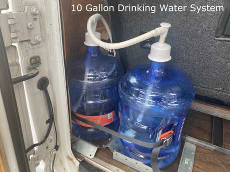 Stay hydrated on your rv rental adventure with this 10-gallon drinking water system, featuring two large blue jugs secured inside a vehicle.