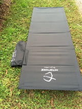 Portable gray mat and bag, perfect for comfortable outdoor sleeping during your RV rental.