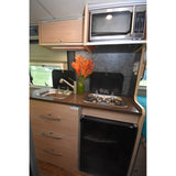 Efficient Hymer RV rental kitchen: sink, two-burner stove, microwave, and wooden storage for convenience.
