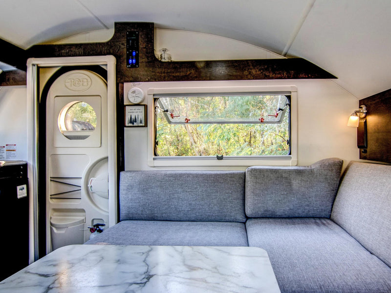  adjacent to a dinette. Keys hang by the counter.|Cozy RV rental interior with a kitchen — photo 13