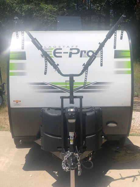 Front of a white Flagstaff E-Pro travel trailer with a bike rack. Perfect for an rv rental adventure!