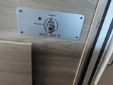 Close-up of an eco-HOT control panel in an RV rental, showing the dial for PRE-HEAT and NORMAL water heater settings.