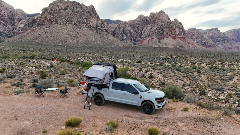 RV rental adventure! Pickup truck with rooftop tent set up for desert camping amid stunning mountains. — photo 4