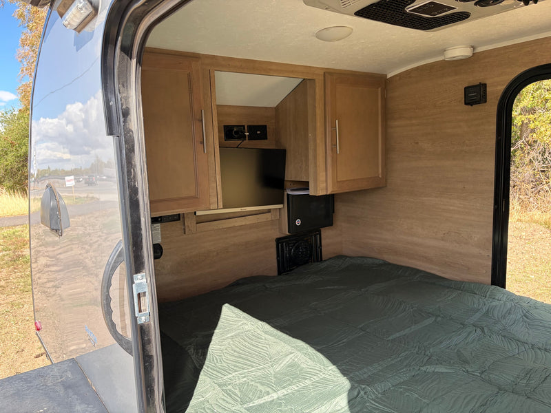  and climate controls.|Cozy RV rental interior with a comfortable bed — photo 8