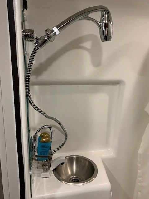  & ample storage.|Experience RV rental comfort: detailed view of a compact kitchen — photo 25