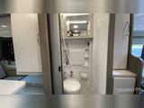 Compact RV rental interior: wet bath with toilet and shower. Modern design for comfortable travel.