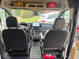 rv rental van's front cabin: detailed view of dashboard, large screen, swivel seats, overhead storage, & a fire extinguisher.