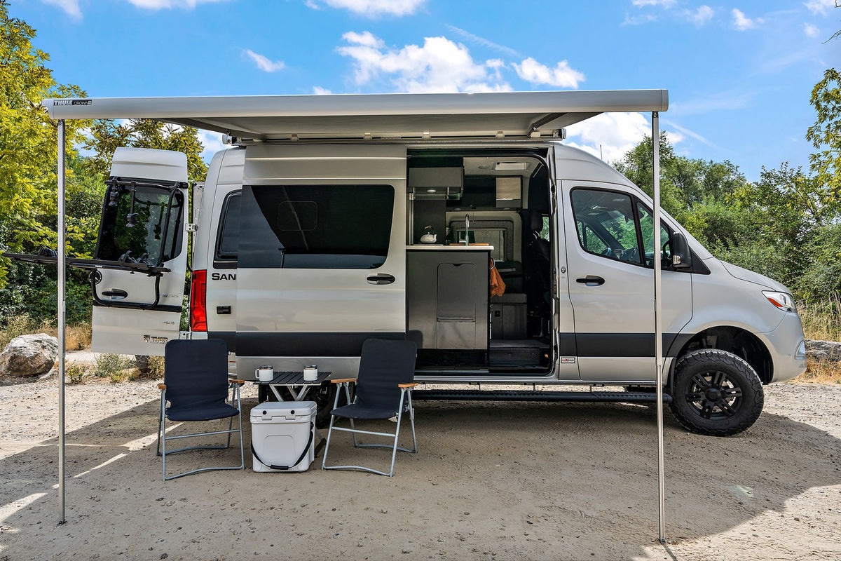  and bunk beds. Enjoy the view on your next adventure!|Silver RV rental camper van parked on a dirt road with its door open — photo 3