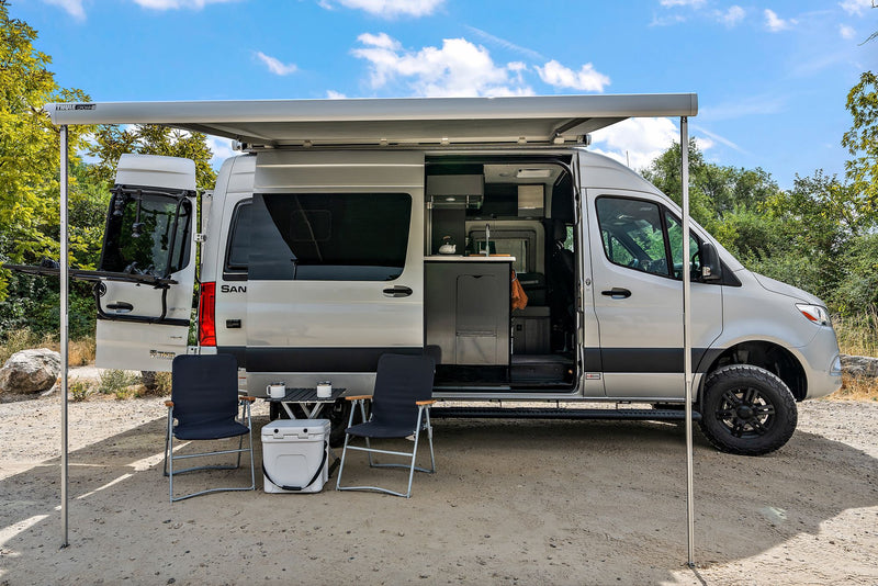  and bunk beds. Enjoy the view on your next adventure!|Silver RV rental camper van parked on a dirt road with its door open — photo 3