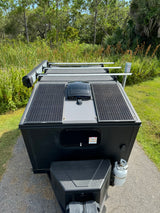 Top-down view of an RV rental trailer with solar panels, ready for off-grid camping and nature adventure.