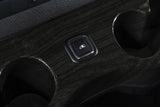 RV rental interior: power liftgate button and cup holders on the dark wood grain console for convenience.