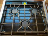 RV rental kitchen: Close-up of a three-burner gas stovetop with black enamel and cast iron grates.