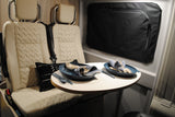 Cozy RV rental dinette: beige seating and a table set for two, perfect for meals on your road trip.
