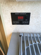 Essential for any **rv rental**: the SeeLevel II tank monitor displaying water/battery levels and pump switch.