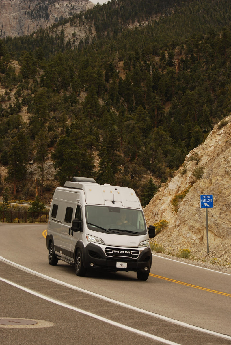  and controls for a comfortable camper experience.|RV rental camper van parked amidst desert rocks & mountains at golden hour — photo 6