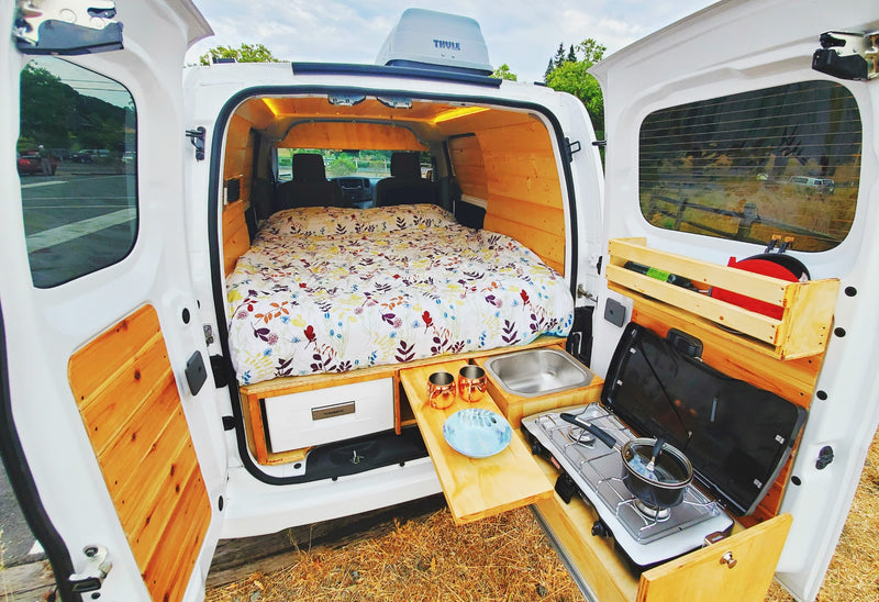 Step into this cozy rv rental campervan! Featuring a comfortable bed, compact kitchen, & fridge for your next adventure. — photo 3