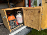 RV rental setup: A Generac generator & Amerigas propane tank stored in a custom wooden compartment inside a van.
