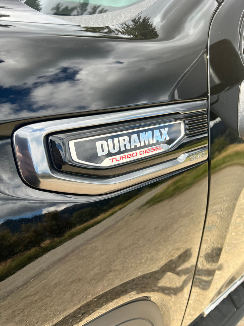 Side view of a black GMC truck, highlighting its "DURAMAX TURBO DIESEL" badge. Ideal for hauling an rv rental or heavy loads. — photo 10