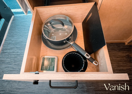 RV rental kitchen essentials: compact pot, coffee filter tin, and pour-over cone neatly organized in a drawer.