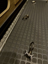 RV rental cargo area with L-track single stud tie-downs & textured floor mat for securing your gear.