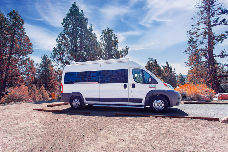  showing two camping chairs and a mat outside.|Cozy RV rental interior featuring a dinette — photo 8