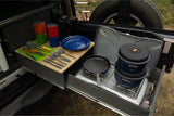 RV rental kitchen setup with pull-out stove, pots, pans, and utensils for easy outdoor cooking. Perfect for camping.