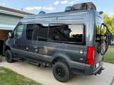 Gray Sanctuary rv rental camper van, a Mercedes-Benz Sprinter conversion, with bike rack & utility hookups.
