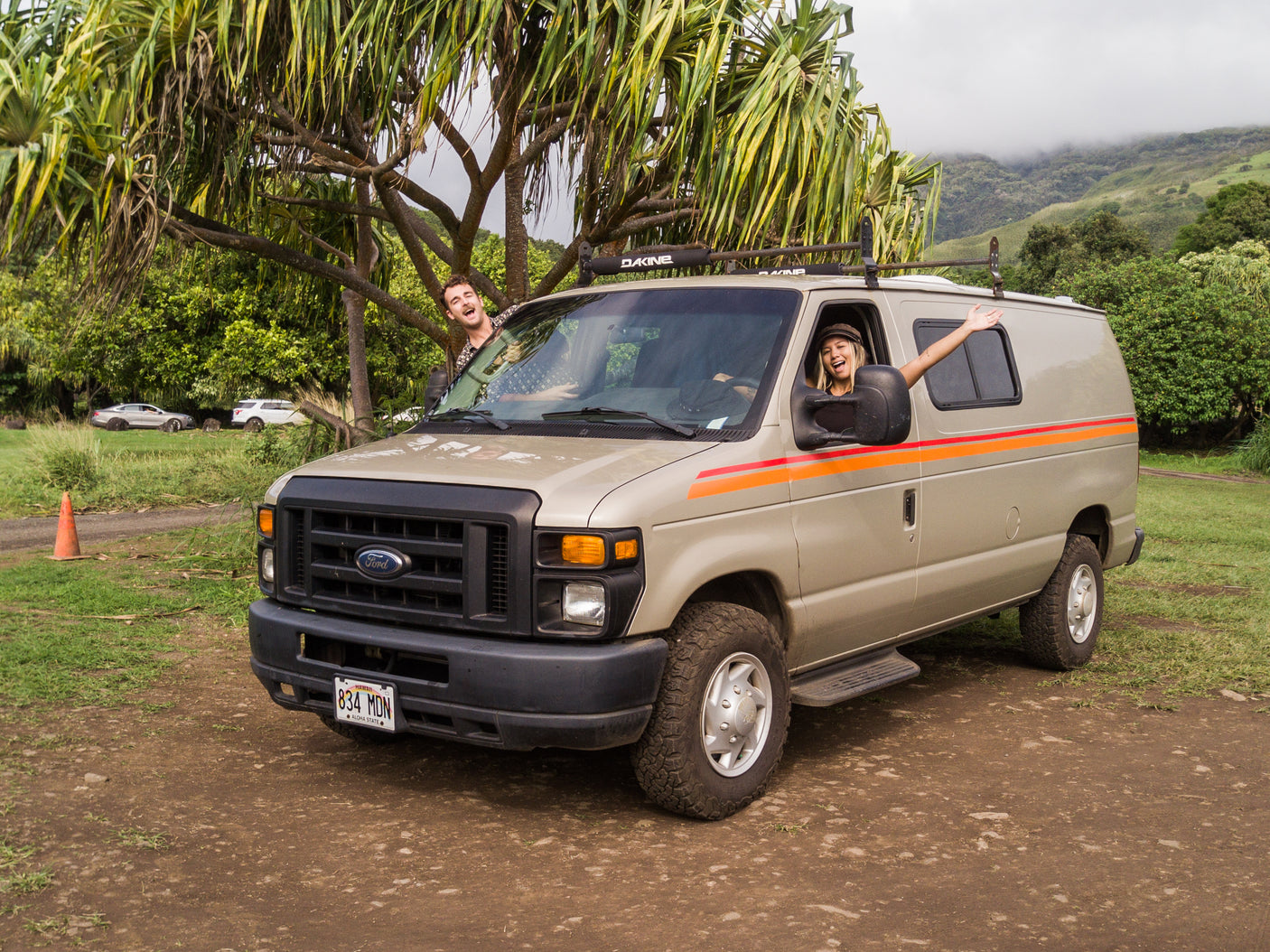Two friends enjoy their Hawaii road trip in a rented camper van. This fun RV rental is perfect for a tropical island adventure!