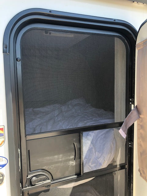 RV rental interior window with mesh screen & retracted privacy blind, ensuring bug protection.