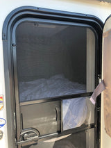 RV rental interior window with mesh screen & retracted privacy blind, ensuring bug protection.