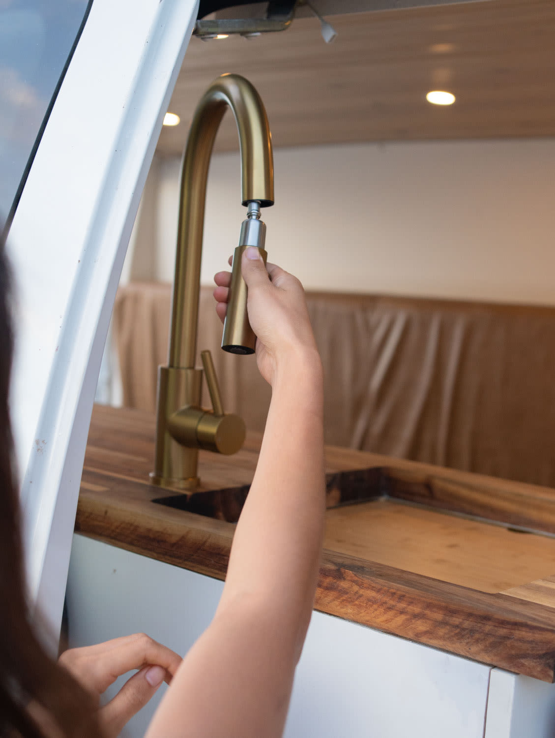 and a fold-out table.|Inside an RV rental! This beautifully designed campervan features a compact kitchen — photo 5