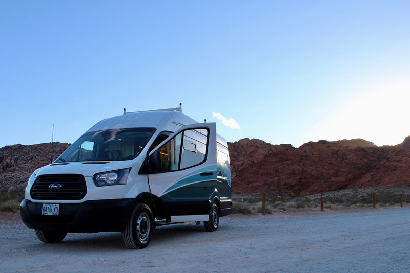 Scenic desert camping with a white RV rental van, door open, amidst red rock mountains. Ideal for road trips! — photo 7