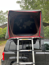  a world map design awaits for your next car camping trip.|Black SUV with iKamper roof-top tent set up for camping. Great rv rental alternative for outdoor adventures.