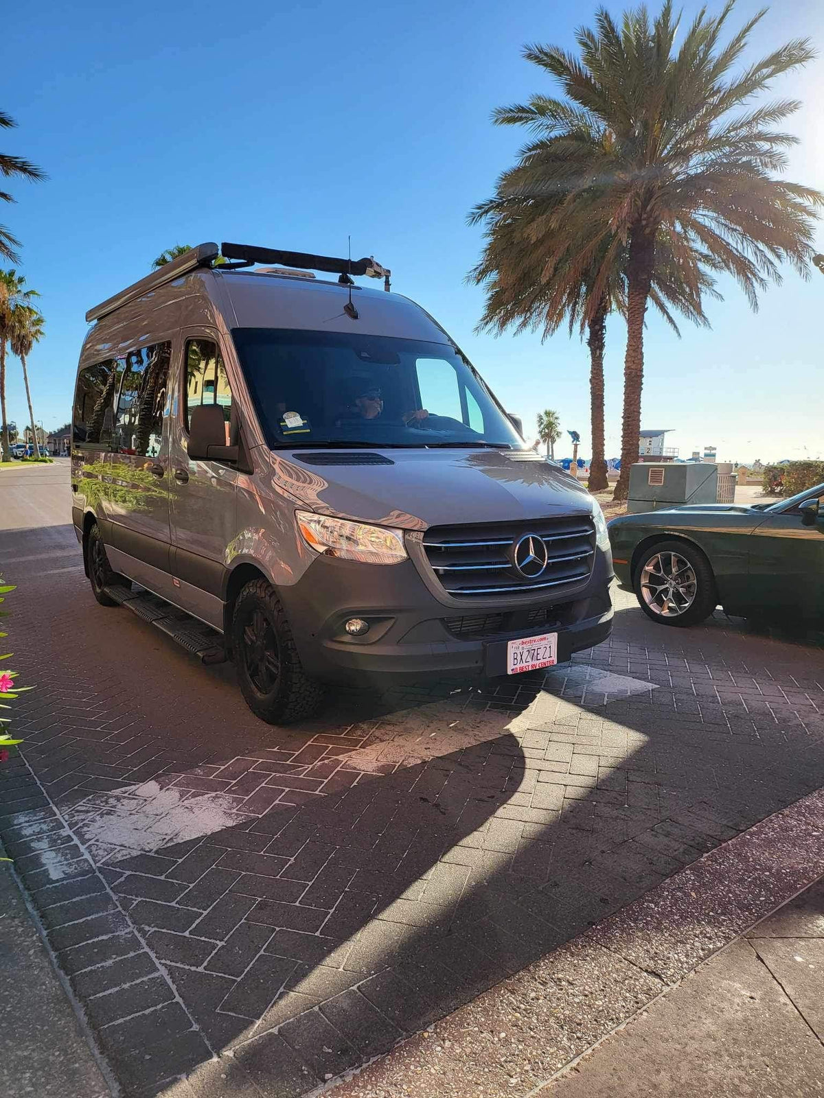 Explore the coast! This sleek gray Mercedes Sprinter RV rental is ready for adventure under sunny skies near the beach. — photo 3