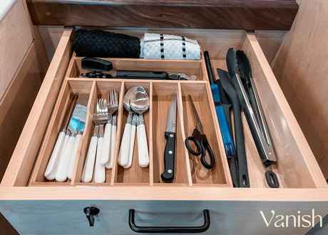 Well-organized RV kitchen drawer with bamboo organizer, cutlery, utensils, and towels, perfect for your next rv rental adventure.