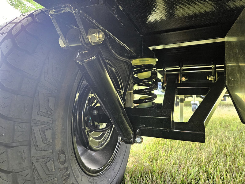  and ceiling net storage.|This black OTG camper/RV rental features a convenient slide-out storage tray & shelving for camping gear.|Black OTG camper trailer with pull-out solar panel & rooftop tent for your next RV rental adventure.|Detail of an RV rental's rear: LED lights — photo 14